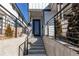 Modern home entrance with metal railings, steps leading up to a sleek front door and contemporary design at 8 S Colorado Blvd, Denver, CO 80246