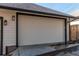 Exterior view of a two car garage with carriage door, dark trim and modern lighting at 8 S Colorado Blvd, Denver, CO 80246