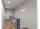 Bright hallway with modern railing, smooth wood floors, and contemporary wall lighting at 8 S Colorado Blvd, Denver, CO 80246