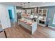 Open kitchen with large island, stainless appliances, designer lighting, and sleek cabinetry at 8 S Colorado Blvd, Denver, CO 80246