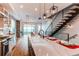 Open floor plan featuring a modern kitchen island, stylish lighting, and easy access to staircase at 8 S Colorado Blvd, Denver, CO 80246