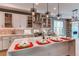 Modern kitchen features a large island, quartz countertops, and designer pendant lighting at 8 S Colorado Blvd, Denver, CO 80246