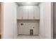 Functional laundry room with overhead cabinets and utility connections, ready for appliance installation at 8 S Colorado Blvd, Denver, CO 80246