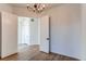 Bright living room featuring elegant chandelier, wood floors, and white trim and door frames at 8 S Colorado Blvd, Denver, CO 80246