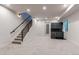 Open-concept living room with gray carpet, black metal staircase and a bar area with a beverage fridge at 8 S Colorado Blvd, Denver, CO 80246