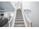 Bright, spacious entryway with a carpeted staircase and white railings at 30093 Chisholm Trl, Elizabeth, CO 80107