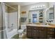Bathroom with a double sink vanity, bathtub and shower with curtain at 4730 Copeland Cir # 203, Highlands Ranch, CO 80126