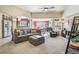 Comfortable living room with neutral carpet, stylish furniture, and bright connecting dining area at 4730 Copeland Cir # 203, Highlands Ranch, CO 80126