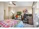 Well lit primary bedroom with a ceiling fan, a desk and a door to the balcony at 4730 Copeland Cir # 203, Highlands Ranch, CO 80126