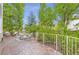 Inviting back deck with ample seating space for outdoor dining and entertaining, surrounded by lush greenery at 5206 S Meadow Lark Dr, Castle Rock, CO 80109