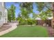 Lush backyard with well-maintained lawn, mature trees, and an inviting patio area at 5206 S Meadow Lark Dr, Castle Rock, CO 80109