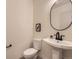 Clean powder room featuring a modern pedestal sink and minimalist design at 5206 S Meadow Lark Dr, Castle Rock, CO 80109