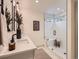 Elegant bathroom featuring a double vanity, decorative mirrors, and a glass-enclosed shower at 5206 S Meadow Lark Dr, Castle Rock, CO 80109