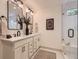 Stylish bathroom featuring double sinks, decorative mirrors, and a glass-enclosed shower at 5206 S Meadow Lark Dr, Castle Rock, CO 80109