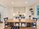 Cozy dining room featuring a wooden table, matching chairs, and custom cabinets with overhead lighting at 5206 S Meadow Lark Dr, Castle Rock, CO 80109