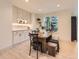Bright dining area featuring custom cabinets with lighting, a modern table, and a bench by a window at 5206 S Meadow Lark Dr, Castle Rock, CO 80109