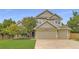 Charming two-story home featuring a three-car garage, well-maintained lawn and beautiful, mature trees at 5206 S Meadow Lark Dr, Castle Rock, CO 80109