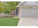 Inviting home exterior featuring a beautiful front door, manicured lawn, and a spacious three-car garage at 5206 S Meadow Lark Dr, Castle Rock, CO 80109