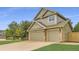 Charming two-story home with a well-manicured lawn, three-car garage, and inviting curb appeal at 5206 S Meadow Lark Dr, Castle Rock, CO 80109