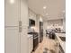 Modern kitchen with stainless steel appliances, a center island and custom cabinets adjacent to dining area at 5206 S Meadow Lark Dr, Castle Rock, CO 80109