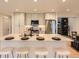 Bright, open kitchen with stainless steel appliances, center island seating, and dining area with custom cabinets at 5206 S Meadow Lark Dr, Castle Rock, CO 80109