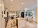 Open concept kitchen with a large center island, stainless steel appliances, and adjacent dining and sitting areas at 5206 S Meadow Lark Dr, Castle Rock, CO 80109