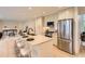 Bright kitchen features a breakfast bar, stainless steel appliances, and light wooden floors at 5206 S Meadow Lark Dr, Castle Rock, CO 80109