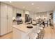Modern kitchen featuring a center island with seating, stainless steel appliances, and custom cabinets with lighting at 5206 S Meadow Lark Dr, Castle Rock, CO 80109