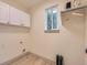 Well-lit laundry room with storage cabinets and washer-dryer hookups at 5206 S Meadow Lark Dr, Castle Rock, CO 80109