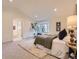 Inviting main bedroom with a sitting area, bay windows, and ensuite bathroom at 5206 S Meadow Lark Dr, Castle Rock, CO 80109