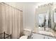 Bathroom with hardwood floors, bathtub with shower, and granite vanity mirror at 8391 S Upham Way # 209, Littleton, CO 80128