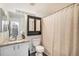 Bathroom features granite counters, wood floors, decorative mirror, and bathtub with shower at 8391 S Upham Way # 209, Littleton, CO 80128