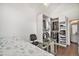 Bedroom with hardwood floors and closet organizer and vanity mirror with glass desk at 8391 S Upham Way # 209, Littleton, CO 80128