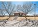 Community brick building featuring stairs leading to the entrance and barren trees on the property at 8391 S Upham Way # 209, Littleton, CO 80128