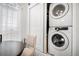 Convenient in-unit stacked washer and dryer tucked neatly away, adjacent to dining nook at 8391 S Upham Way # 209, Littleton, CO 80128