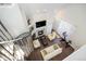 Spacious living room with fireplace, TV, spiral staircase, and bright natural light at 8391 S Upham Way # 209, Littleton, CO 80128