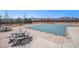 Community pool area featuring picnic tables and benches and distant views of the mountains at 8391 S Upham Way # 209, Littleton, CO 80128