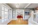 Entryway with hardwood floors, vintage radiator, and view into the dining room at 2062 Eudora St, Denver, CO 80207