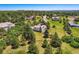 Aerial view of a home nestled among mature trees with a fenced-in yard in a lush neighborhood at 18680 Knollwood Blvd, Monument, CO 80132