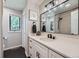 Modern bathroom featuring black fixtures, matte black floor, and a large framed mirror with globe sconces at 18680 Knollwood Blvd, Monument, CO 80132