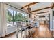 Charming dining area featuring wood floors, exposed beams and a large window overlooking the lush yard at 18680 Knollwood Blvd, Monument, CO 80132