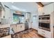 Modern kitchen with stainless steel appliances, updated cabinets and wooden floors at 18680 Knollwood Blvd, Monument, CO 80132