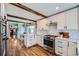 Well-lit kitchen with stainless steel appliances, a breakfast nook, and hardwood floors at 18680 Knollwood Blvd, Monument, CO 80132