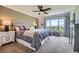 Inviting main bedroom offering a large window with a view, plush carpet and a ceiling fan at 18680 Knollwood Blvd, Monument, CO 80132