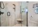New walk-in shower provides sleek tile with built in shelves, corner seat, and glass door at 18680 Knollwood Blvd, Monument, CO 80132