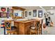 Basement bar area featuring hardwood cabinets, bar top, and ample seating at 11830 Snowshoe Dr, Parker, CO 80138