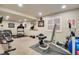 Home gym equipped with weights, treadmill, and workout bench near a window with bright natural light at 11830 Snowshoe Dr, Parker, CO 80138
