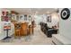 Basement with bar area featuring wooden bar, bar seating, and home theater recliners at 11830 Snowshoe Dr, Parker, CO 80138