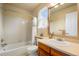 Bright bathroom featuring a tiled shower/tub, neutral countertops, and ample natural light from the window at 11830 Snowshoe Dr, Parker, CO 80138