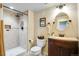 Bathroom with tiled shower, vanity with sink, mirror, and toilet at 11830 Snowshoe Dr, Parker, CO 80138